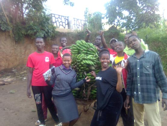 Young farmers celebrating their harvest and getting ready to distribute it to the hungry community members. 