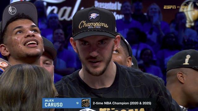 A close-up of Alex Caruso during the Thunder’s championship celebration. He wears a black OKC “Champions 2024/2025” hat and looks intensely focused as he speaks to the ESPN reporter. A blue on-screen graphic reads “Alex Caruso, 
