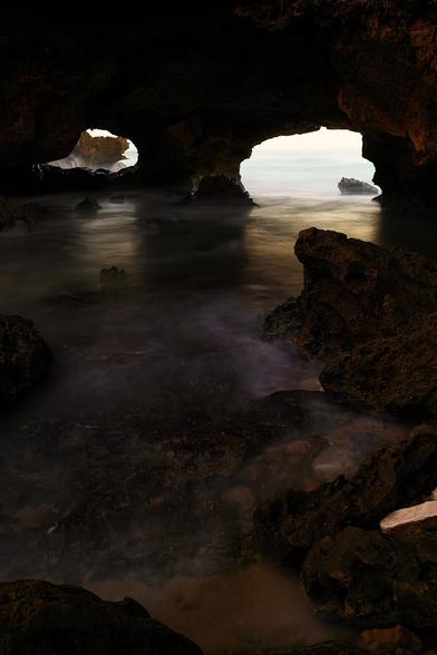 London Bridge in Portsea, Victoria, is a striking natural rock formation located along the scenic Mornington Peninsula coastline, just a couple of hours’ drive from Melbourne. This limestone arch juts out into the ocean, shaped over thousands of years by the relentless force of wind and waves. A favourite spot for photographers and tourists alike, it offers dramatic views of the wild Bass Strait and the rugged cliffs that define this part of the coast. Nearby, the beaches and walking tracks provide opportunities to explore the area's natural beauty. Though swimming is not advised due to strong currents, the location is perfect for a coastal stroll, especially at sunset when the rock glows in golden light.