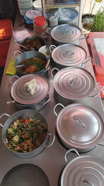 a row of bowls with different soups for lunch