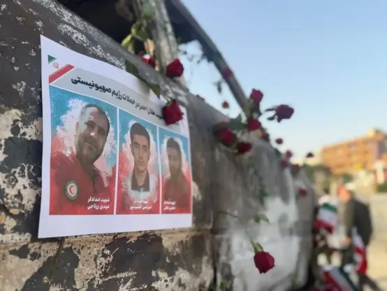 Colour posters of people killed in Israeli attack on an ambulance in Tehran - driver, paramedic, patient.