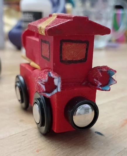 #CustomMade #woodentrain #IronMan, back view of  booster rockets, whose fire (made with little strips of felt)  is so hot it burns white & blue on the inside, lol!