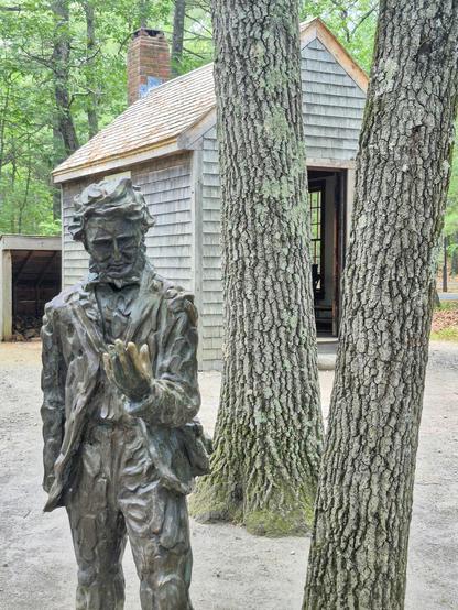 Statue of Henry David Thoreau outside his recreated cabin near Walden Pond.