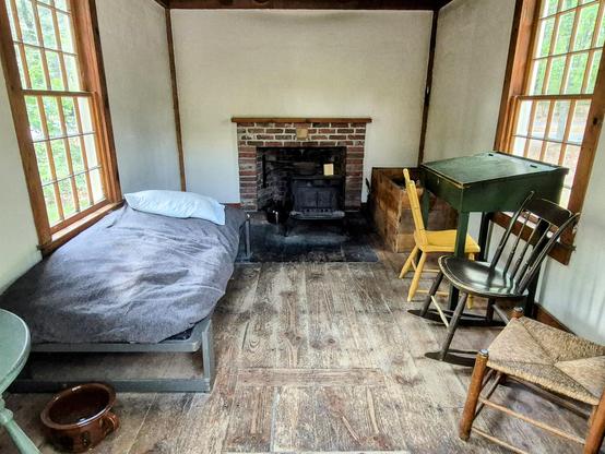 Inside Thoreau's cabin. Note the 3 chairs: one for solitude, two for friendship, and three for society.