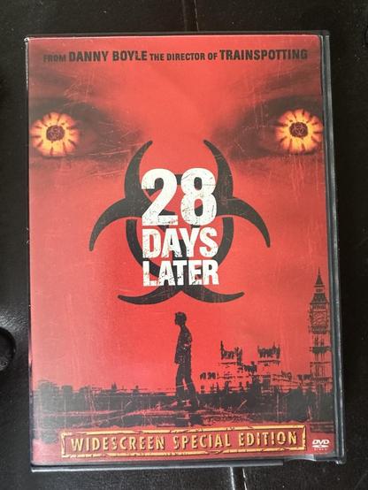 DVD Cover for 28 Days Later

Basically a red background with the large words 28 Days Later (Widescreen Special Edition) on the cover

Top part has Red/Orange Eyes that look to be glowing facing forward, no nose, but a symbol that looks like 3 sets of 2 horns a set facing up and the other 2 facing to bottom left corner and lower right corner

The bottom has the outline of a black figure walking across the page from right to left (facing left) and UK Parliament building in the right side of the page