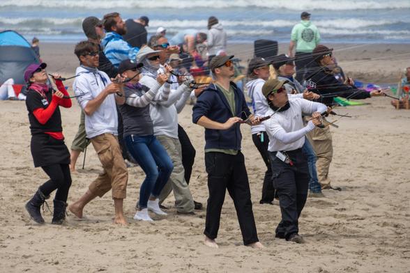 A group of sport kite flyers during a mega-fly
Includes Katrina Bruland, John Barresi, Scott Abbott, Kristian Slater, Sari Becker, Jim Doman, Scott Weider, Spencer Watson, Meshelle Sharples, Dylan Nguyen, Sarah Russel, and Linzy Abbott