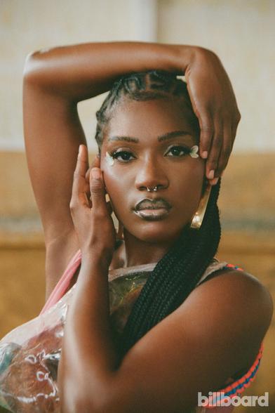 Beautiful young (Gen Z) black bisexual cis woman rapper/singer with gorgeous braids.