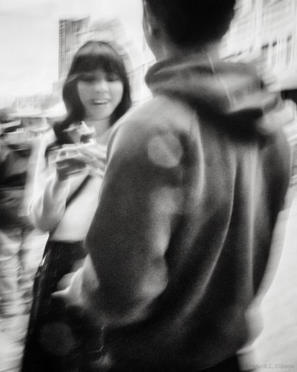 Black and white ICM photo of a couple with smiling woman.
