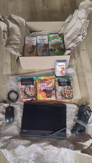 Notebook + Süßigkeiten auf Paketmaterial