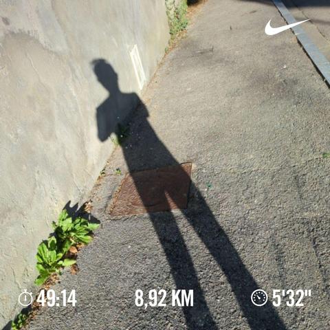 A photo of my shadow on the asphalt pavement.