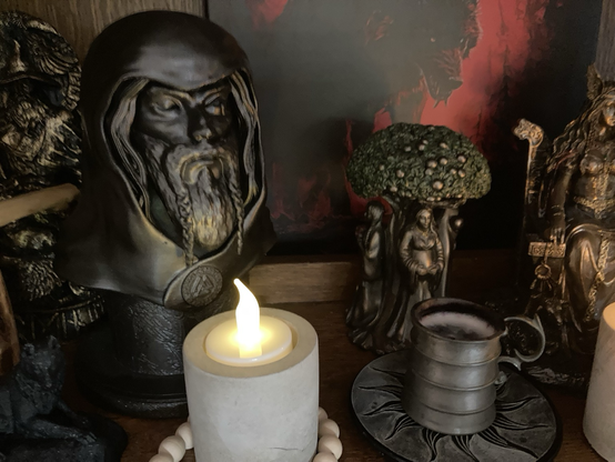 Pagan altar with Odin statuette and offering of beer
