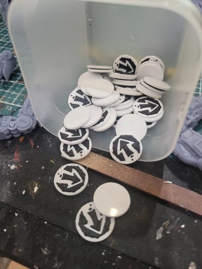 An assortment of black and white printed tokens.