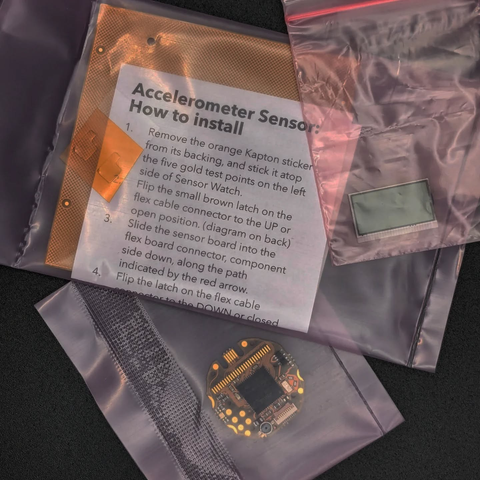 The Sensor Watch Pro PCB, custom LCD, and accelerometer sensors inside individual plastic bags.