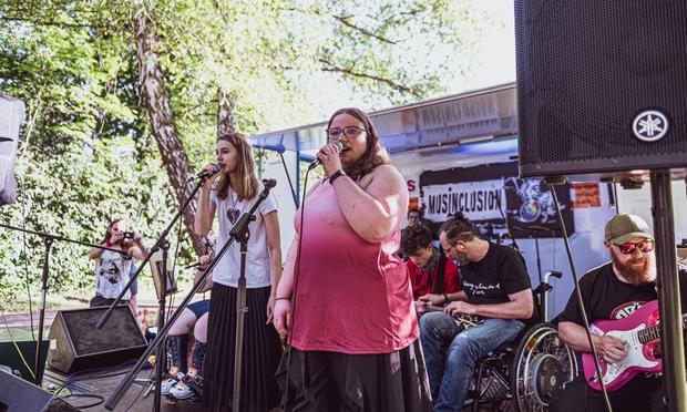 A diverse group of musicians performing together on stage, engaging the audience with their lively music.