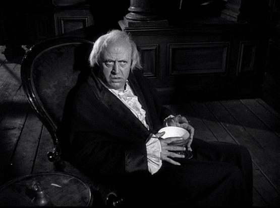 Alastair Sim as Ebenezer Scrooge.