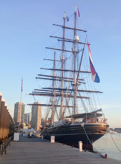 Stern shot of the tall ship Stad Amsterdam tied up on a calm sunny morning.