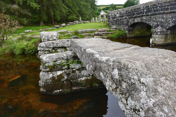 Two bridges span a moorland river.