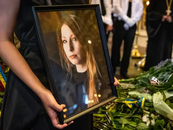 A picture of Victoria Amelina held by a friend at her funeral