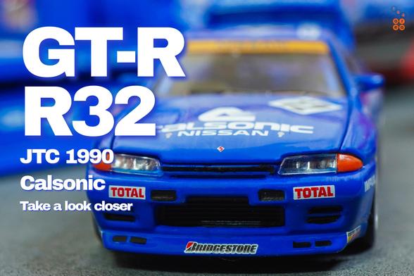 A close-up shot of Nissan Skyline GT-R R32, JTC 1990 on Calsonic livery in 1:64 scale with 1:64 figure on AREA 164