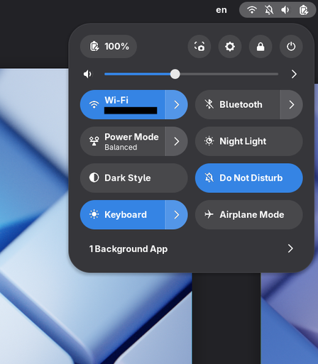 GNOME Shell quick settings on a laptop, including a quick setting for Do Not Disturb (moved from the calendar popover in the center). There's a strikethrough bell icon in the top panel with the other system indicators since Do Not Disturb is on.