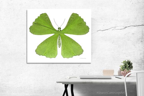 Green Gingko leaves forming a butterfly shape on crisp white in a furniture setting.