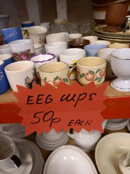 a bunch of cups that are labeled "EEG CUPS 50p EACH"