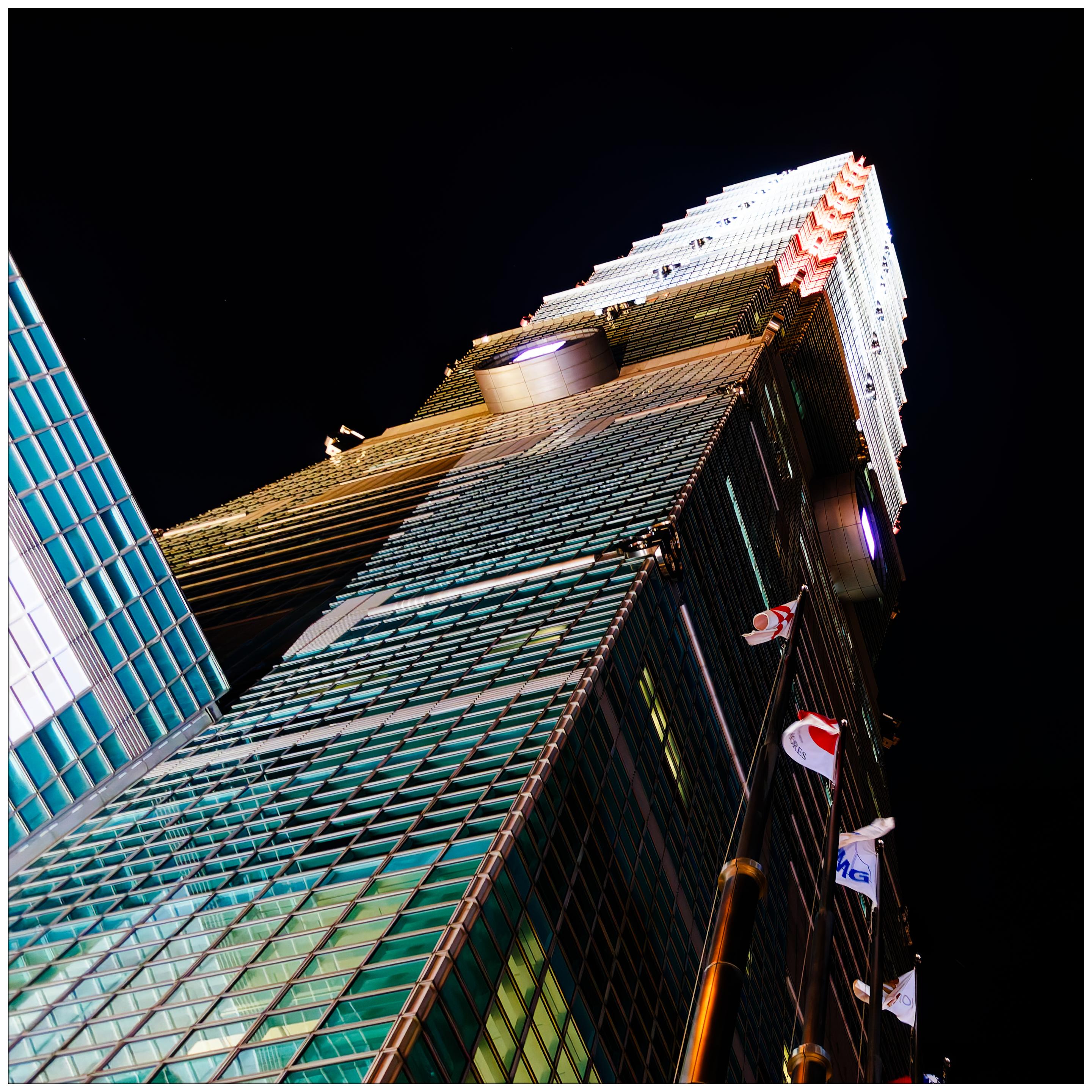 Frog’s-eye view of the illuminated Taipei 101 tower at night. Frog’s-eye view of the illuminated Taipei 101 tower at night.