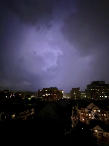 A wider shot over Courthouse with some lighting inc in the middle of cloud making it glow a pale purplish color