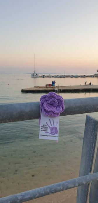 a knittet purple rose on a beach on pag island, croatia