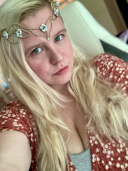 selfie of queen in a floral dress and a gold crown