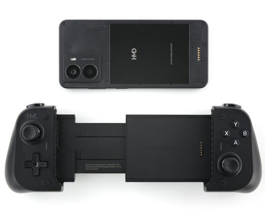 HMD Fusion Gaming Outfit with its HMD smartphone placed above it. The phone is upside down, while the controller is right side up. This showcases the pin connectors on the back of the phone and front of the joystick, which is how they connect together. The controller's joysticks are offset, like an Xbox or Nintendo Switch Pro controller.