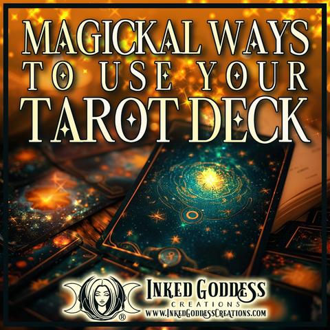 A deck of dark teal tarot cards is spread haphazardly face-down on a table. The design on the back features vintage-style stars and swirling designs.. The text is the title of our Inked Grimoire blog post, "Magickal Ways to Use Your Tarot Deck." Presented by Inked Goddess Creations.