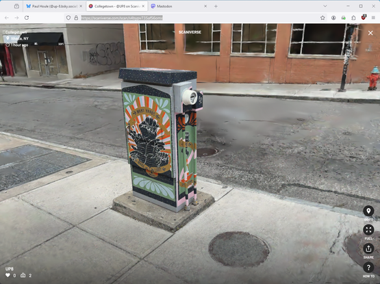 Decorated electrical box on a sidewalk by an empty street.