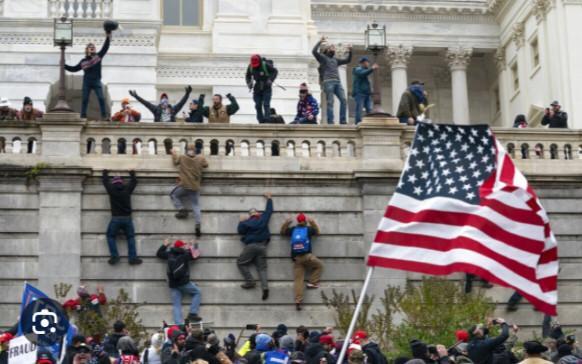 Rioters scale a wall at the U.S. Capitol on Jan. 6, 2021, in Washington. (AP Photo/Jose Luis Magana)