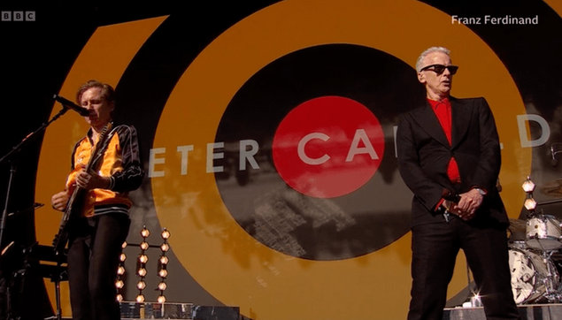 Peter Capaldi on stage with Franz Ferdinand at Glastonbury