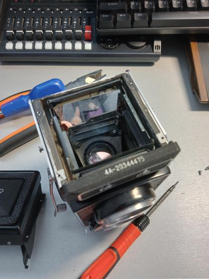 The photo shows a disassembled medium-format Seagull 4a camera.