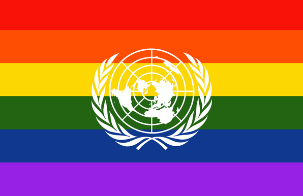 The rainbow flag with the emblem of the United Nations superimposed in the middle of it.