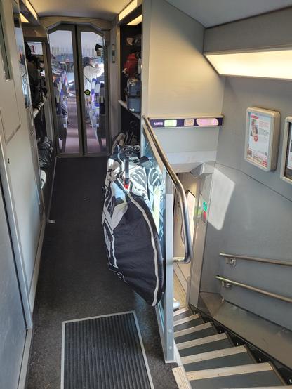 Packed bicycle along the railing upstairs of a TGV Lyria Zurich-Paris.