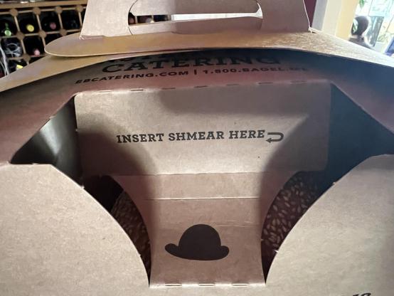 a Einstein bagel box with a closeup of the cream cheese cutout