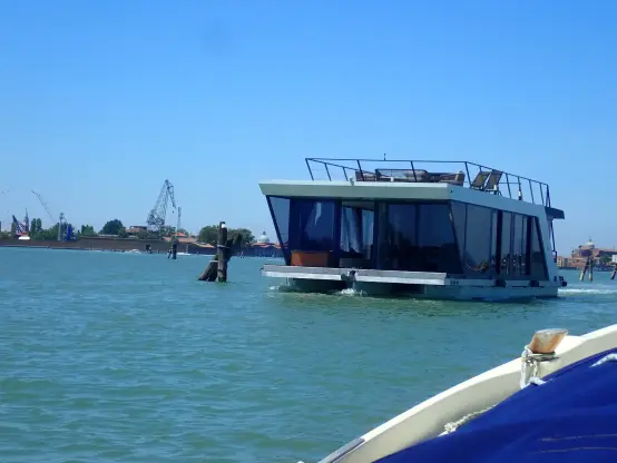 A box shaped kind of house-boat, glass on all sides and some kind of terrace on top.