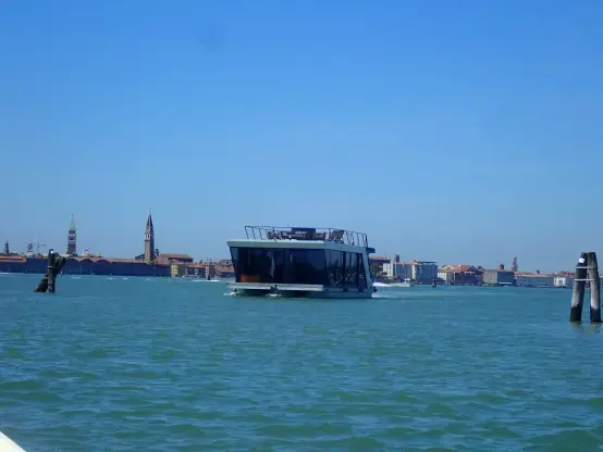 A box shaped kind of house-boat, glass on all sides and some kind of terrace on top.
