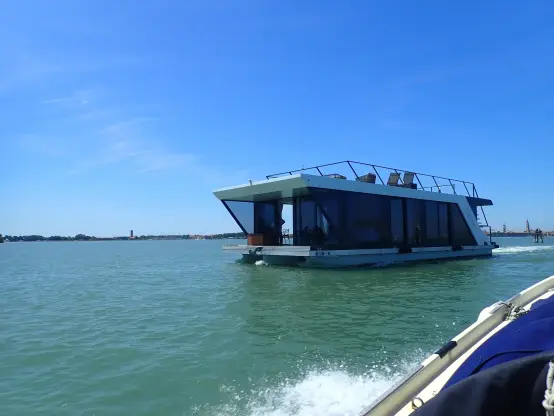A box shaped kind of house-boat, glass on all sides and some kind of terrace on top.