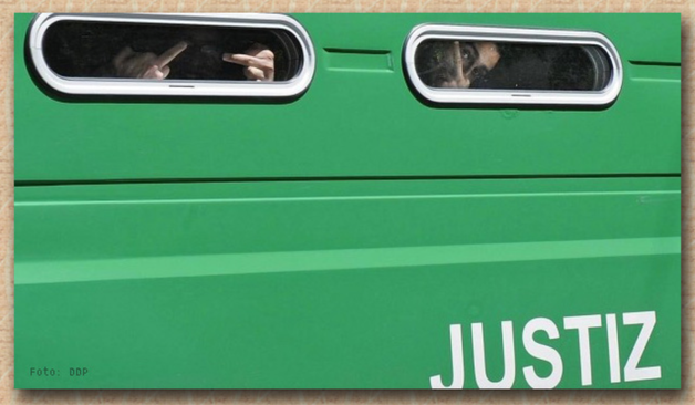 Gefangenentransporter im Sonnenlicht, Gefangene hinter den Fenstern wirken nicht zufrieden.