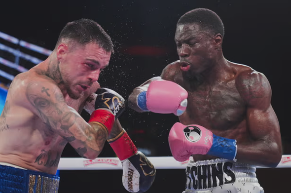 A blank man on the right wearing pink gloves and a bare torso has is arms in front of himself defensively (I think) confronting a white man on the left with red, black and white gloves with a spray of moisture around them.