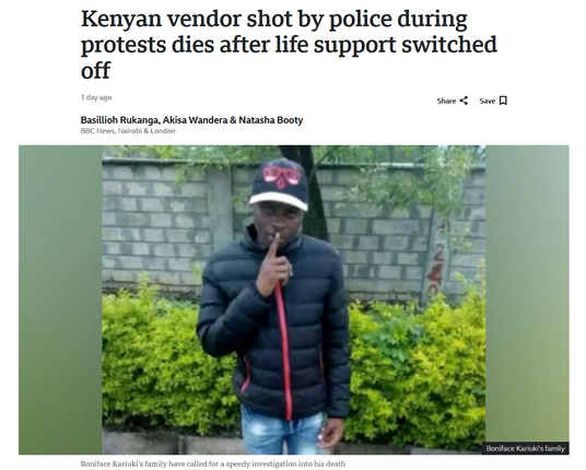 The image is a screenshot of a news article from BBC News. The headline reads: "Kenyan vendor shot by police during protests dies after life support switched off." The article is dated 1 day ago and is written by Basilioh Rukanga, Akisa Wandera, and Natasha Booty from BBC News, Nairobi & London.

The main image shows a man standing outdoors. He is wearing a black puffer jacket with a red zipper, blue jeans, and a black cap with a red design. He is holding his finger to his lips in a 'shushing' gesture. The background includes a brick wall and green bushes. The article's subheading states: "Boniface Kariuki's family have called for a speedy investigation into his death."