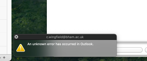 A fragment of a screenshot of an error dialog.
"An unknown error has occurred in Outlook."
The dialog has tiny white text over a blurred glassy background which (due to layered desktop and windows behind it) fades from dark green to mid grey, rendering the text extremely hard to read. The titlebar is dark grey, half of which perfectly blends in with the background. The bounding frame of the dialog are close to indiscernable.