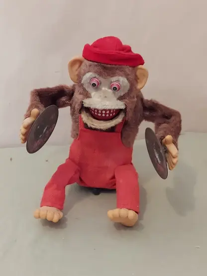 Picture of a horrifying vintage battery operated chimp toy, with scary bugged out eyes and bared teeth, which I cribbed from a random Ebay listing...