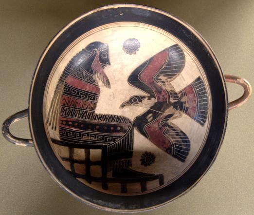 Black-figure vase painting of a seated man facing a flying eagle. The painting depicts either the bound Titan Prometheus tormented by the Caucasian eagle or Zeus seated on a throne with his eagle familiar.