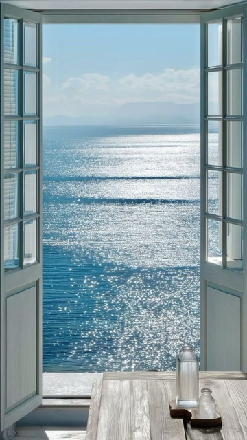 Still ocean, soft morning light, silence through a window — serenity in a frame.