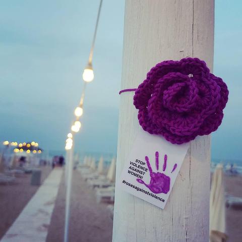 knittet purple rose in Rimini, Italy, Stop violence against women